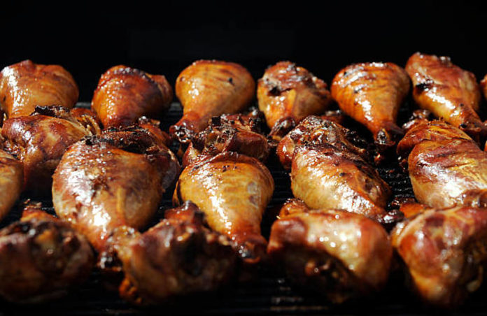 Giant turkey legs sizzle on the grill at the Downtown Denver Partnership's A Taste of Colorado at Civic Center Park in downtown Denver.