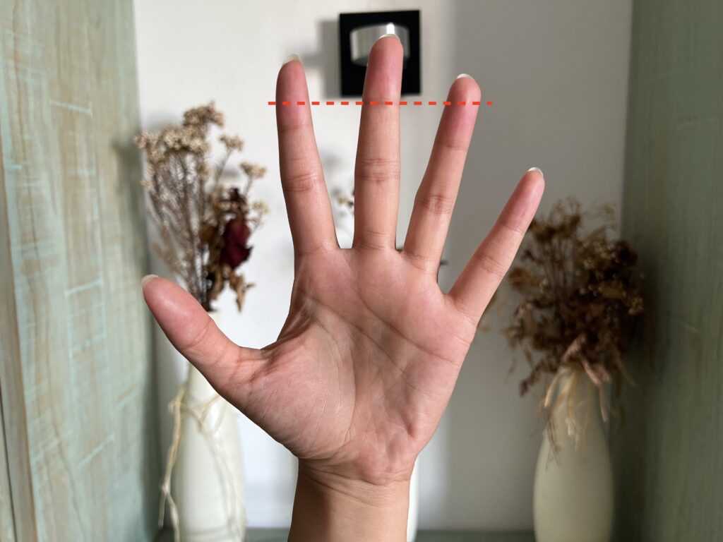 photo of author's hand, indicating top knuckle of middle finger
