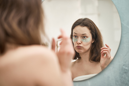 Woman puts eye mask