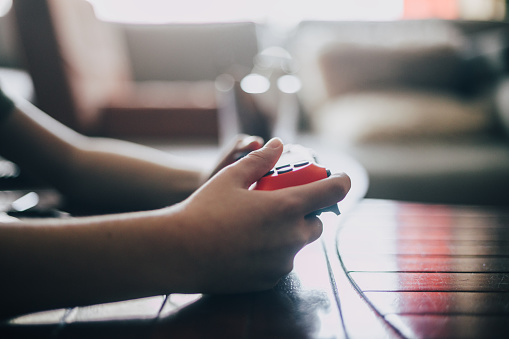 Close up of boy holding video games controller