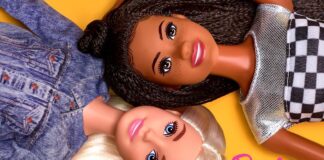 Two Barbie dolls lying down