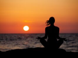 Woman meditating during the sunset